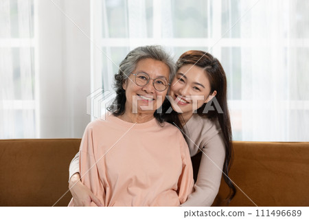 Heartfelt moment as a mid-age woman embraces her elderly mother with a warm and loving hug, celebrating the enduring bond between generations. Family Love Concept 111496689