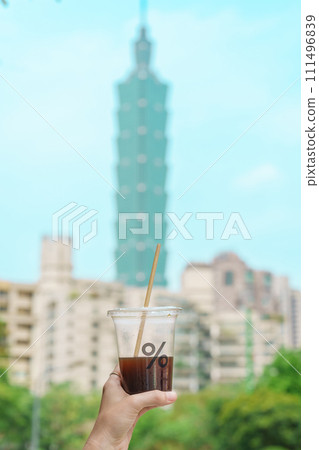 Woman hand holding a glass of % Arabica coffee against Taipei city background. Taipei, Taiwan, 05 April 2023 Woman hand holding a glass of % Arabica coffee against Taipei city background. Taipei, Taiwan, 05 April 2023 111496839