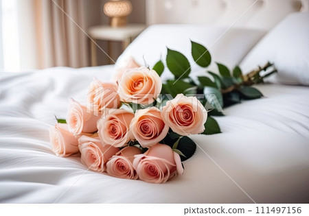 A bouquet of tea roses lies on a white bed in a bright bedroom. A gift for your beloved, Valentine's day, birthday, date. Copy space. AI generated 111497156