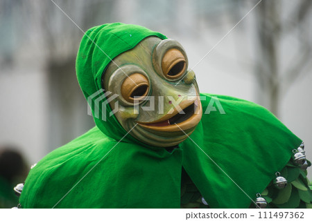 Neuenburg - Germany - 11 february 2024 - Portrait of masked frog people parading in the street 111497362