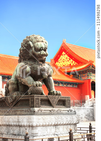 Ancient pavilions and lion statue in Forbidden City. Bronze chinese guardian lion in front of Gate of Supreme Harmony, Forbidden City, Beijing, China 111498298