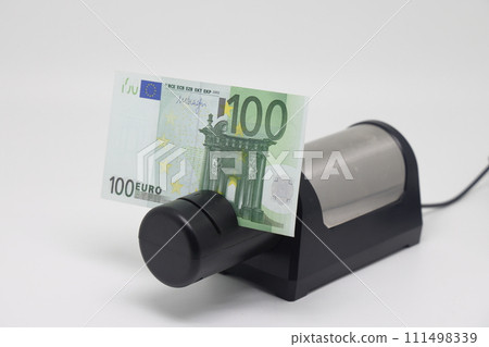 Banknotes and an electric knife sharpener. World financial crisis. The fight against inflation. Banknotes and an electric knife sharpener. World financial crisis. The fight against inflation. 111498339