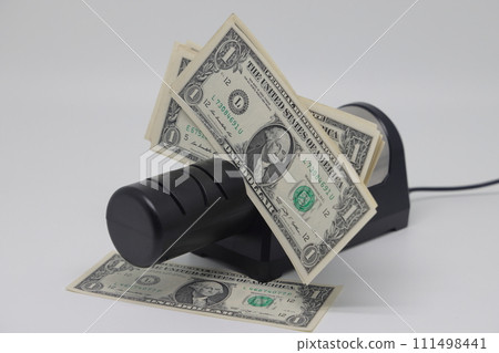 Banknotes and an electric knife sharpener. World financial crisis. The fight against inflation. 111498441