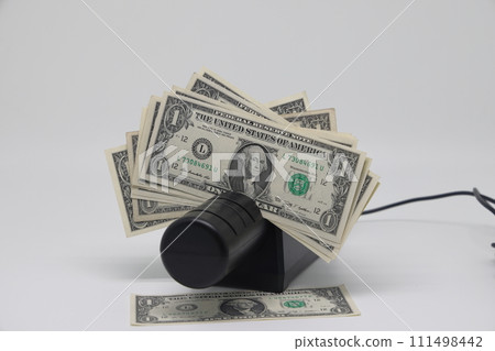 Banknotes and an electric knife sharpener. World financial crisis. The fight against inflation. 111498442