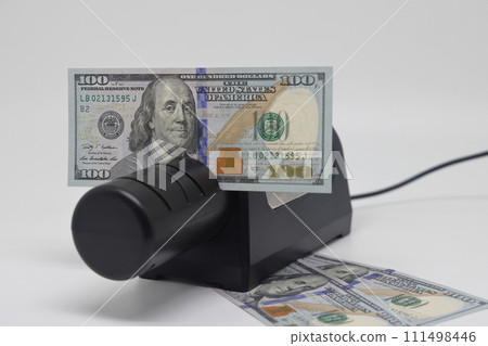 Banknotes and an electric knife sharpener. World financial crisis. The fight against inflation. Banknotes and an electric knife sharpener. World financial crisis. The fight against inflation. 111498446