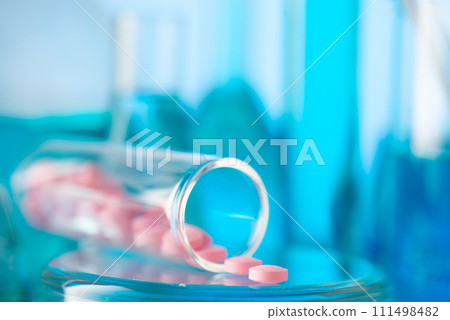 Pink tablets in a chemical test tube. Production of medicines Medicine, pharmaceuticals, chemistry 111498482