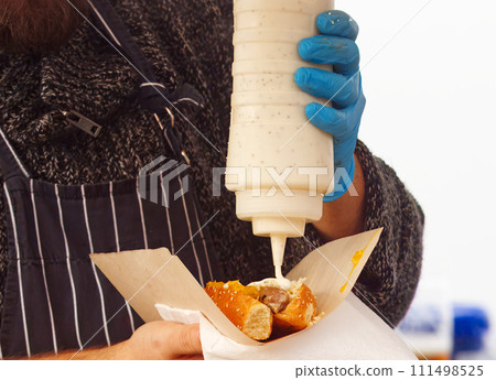 Making hot dogs at farmers market in downtown Prague. Making hot dogs at farmers market in downtown Prague. 111498525