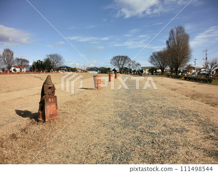 Landscape with playground equipment in winter park Landscape with playground equipment in winter park 111498544