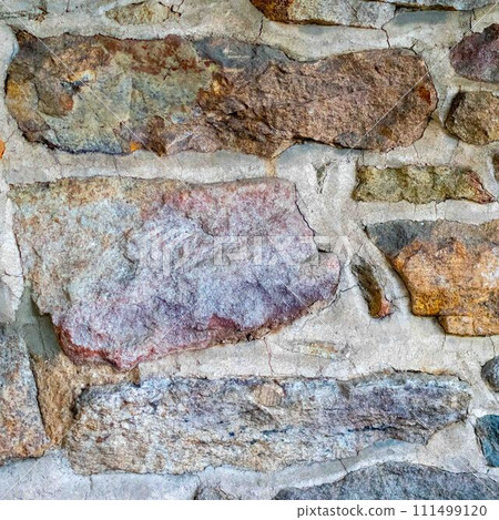 Closeup of colorful field stone fieldstone colonial wall construction 111499120