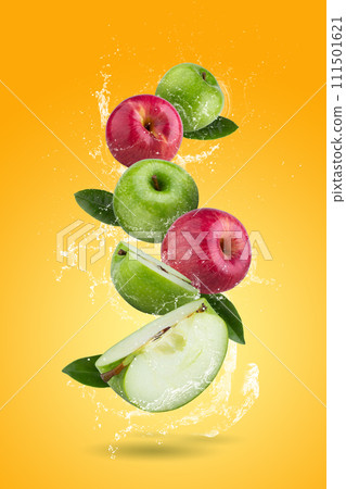 Fresh Red apples and Green apple slices with water splashing on a orange background 111501621