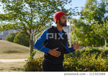 Man running outdoors. Exercising after work for good mental health, physical health, and relieving stress and boost mood. Man running outdoors. Exercising after work for good mental health, physical health, and relieving stress and boost mood. 111501866