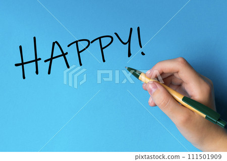 Children hand with pen write on an blue white background. Writing hand. Word HAPPY 111501909