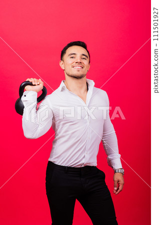 Attractive businessman Exercising With Kettlebell In studio, red background Attractive businessman Exercising With Kettlebell In studio, red background 111501927