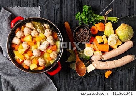 finnish sausage soup with vegetables in red pot finnish sausage soup with vegetables in red pot 111502341