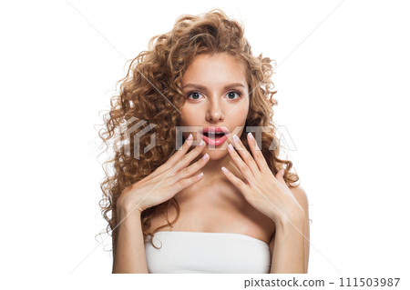 Shocked woman healthy model with natural make-up, shiny clear skin and long curly hairstyle Shocked woman healthy model with natural make-up, shiny clear skin and long curly hairstyle 111503987
