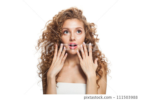 Shocked woman looking up. Healthy female model with natural make-up, shiny clear skin  111503988
