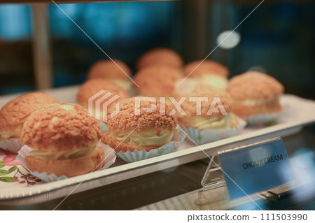 French homemade Choux cream puffs filled with vanilla cream on tray French homemade Choux cream puffs filled with vanilla cream on tray 111503990