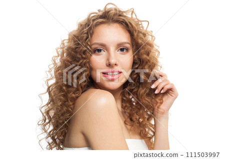 Isolated healthy model with natural make-up, shiny clear skin and long curly hairstyle.  111503997