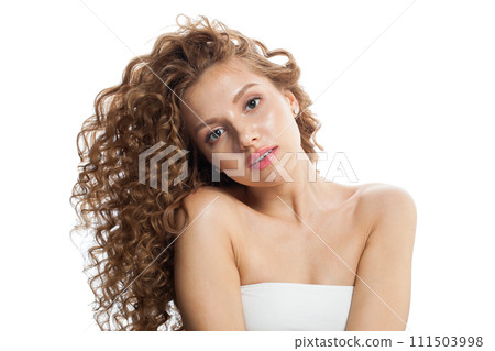Young healthy model with natural make-up, shiny clear skin and long curly hairstyle. Young healthy model with natural make-up, shiny clear skin and long curly hairstyle. 111503998