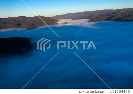Aerial view of mist and clouds in the valley in sunrise 111504490