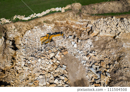 Aerial view of excavator working in a limestone quarry 111504508