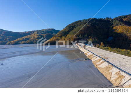 Aerial view of mining residual waters from a copper mine discharging into decanting pond. Geamana, Romania 111504514