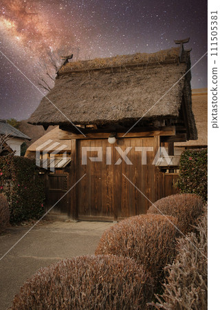 Old Japanese thatched roof house illuminated by starlight 111505381