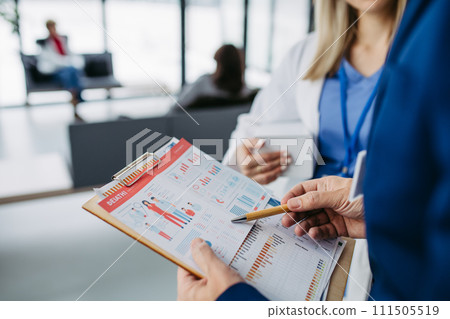 Rear view of pharmaceutical sales representative talking with doctor in medical building. Ambitious male sales representative presenting new medication. 111505519