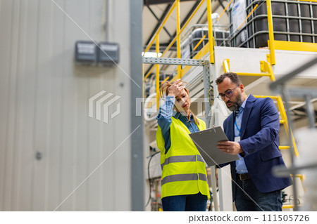 Supervisor, manager scolding employee in modern industry factory. Worker making mistake. Production manger is angry, dissatisfied for worker's poor quality work, safety viaolations. Gender harassment Supervisor, manager scolding employee in modern industry factory. Worker making mistake. Production manger is angry, dissatisfied for worker's poor quality work, safety viaolations. Gender harassment 111505726