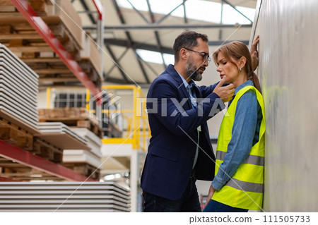 Female worker in manufactury feeling vulnerable and intimidated by superior manager, forced touching at workplace. Sexual harassment at work. Female worker in manufactury feeling vulnerable and intimidated by superior manager, forced touching at workplace. Sexual harassment at work. 111505733