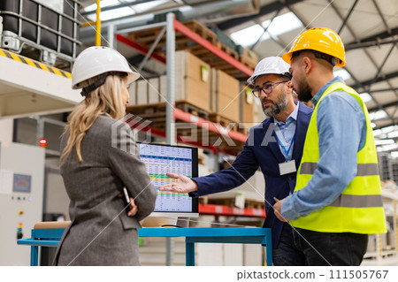 Engineer, foreman consulting with director in modern industrial factory, talking about new production project or investment. Team management in manufacturing facility. Engineer, foreman consulting with director in modern industrial factory, talking about new production project or investment. Team management in manufacturing facility. 111505767