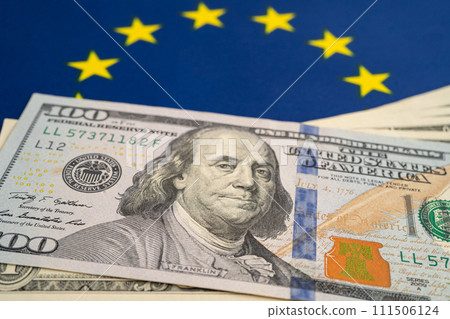 US dollar banknotes on EU flag background, Business and finance. US dollar banknotes on EU flag background, Business and finance. 111506124