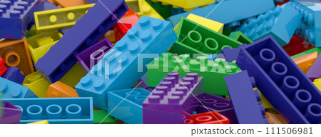 Colored toy bricks background. Rainbow colors. Random coloured plastic construction blocks. 3d illustration 111506981