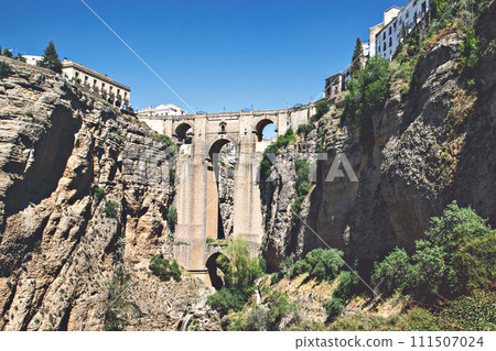 Ronda, Spain. Aerial evening view of New Bridge over Guadalevin River in Ronda, Andalusia, Spain. View of the touristic city. 111507024