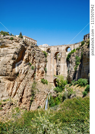 Ronda, Spain. Aerial evening view of New Bridge over Guadalevin River in Ronda, Andalusia, Spain. View of the touristic city. Ronda, Spain. Aerial evening view of New Bridge over Guadalevin River in Ronda, Andalusia, Spain. View of the touristic city. 111507042