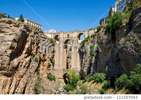 Ronda, Spain. Aerial evening view of New Bridge over Guadalevin River in Ronda, Andalusia, Spain. View of the touristic city. Ronda, Spain. Aerial evening view of New Bridge over Guadalevin River in Ronda, Andalusia, Spain. View of the touristic city. 111507043