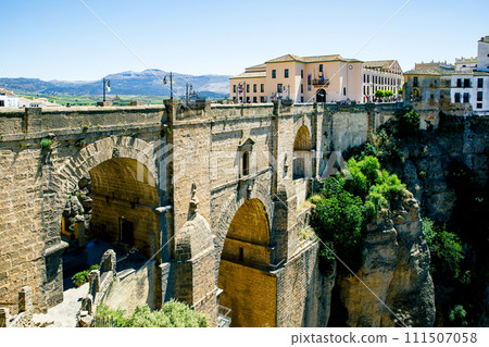 Ronda, Spain. Aerial evening view of New Bridge over Guadalevin River in Ronda, Andalusia, Spain. View of the touristic city. Ronda, Spain. Aerial evening view of New Bridge over Guadalevin River in Ronda, Andalusia, Spain. View of the touristic city. 111507058