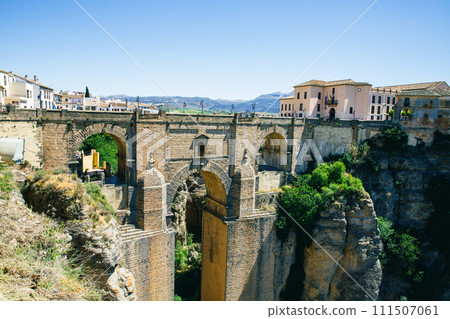 Ronda, Spain. Aerial evening view of New Bridge over Guadalevin River in Ronda, Andalusia, Spain. View of the touristic city. 111507061