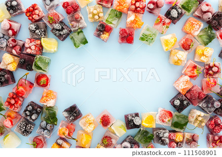 Frame of ice cubes with frozen berries 111508901