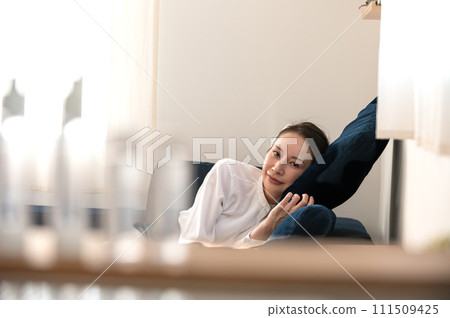 A woman relaxing on the sofa A woman relaxing on the sofa 111509425