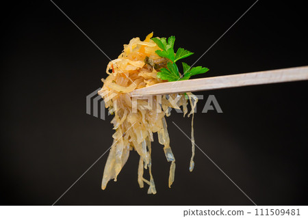 cabbage stewed with spices and carrots on a wooden fork cabbage stewed with spices and carrots on a wooden fork 111509481