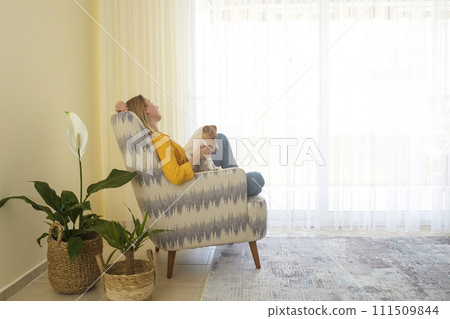 Woman with her jack russell pup at home. Woman with her jack russell pup at home. 111509844
