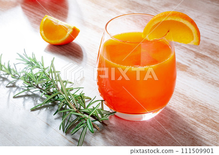 Fresh orange drink with rosemary on a wooden background 111509901
