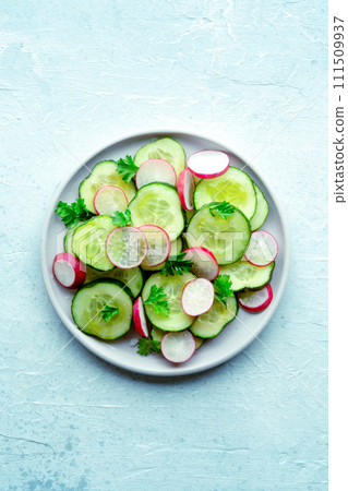 Fresh cucumber and radish salad with parsley, overhead flat lay shot 111509937