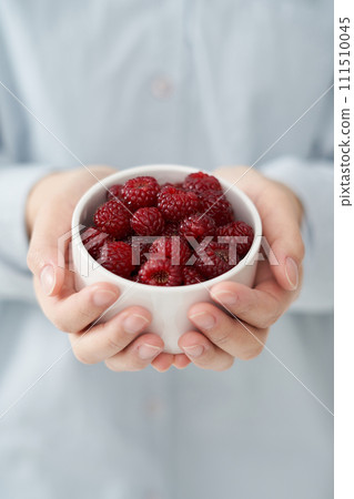 The young woman is holding Raspberry 111510045