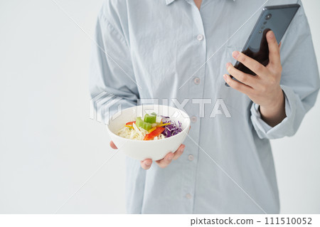 The young woman is holding Salad The young woman is holding Salad 111510052