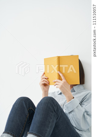 The young woman is holding book 111510057
