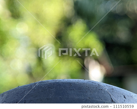 Closeup black surface with blurry nature background.Can be used as a space for writing, text, pictures and others. 111510559