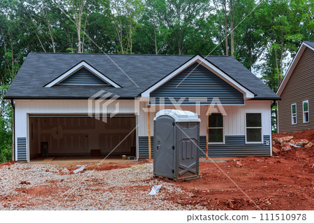 Portable temporary toilet is located on construction site during build home Portable temporary toilet is located on construction site during build home 111510978