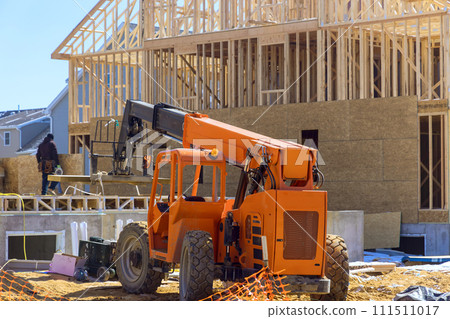 Material delivered to construction site is unloaded by lift manipulator Material delivered to construction site is unloaded by lift manipulator 111511017